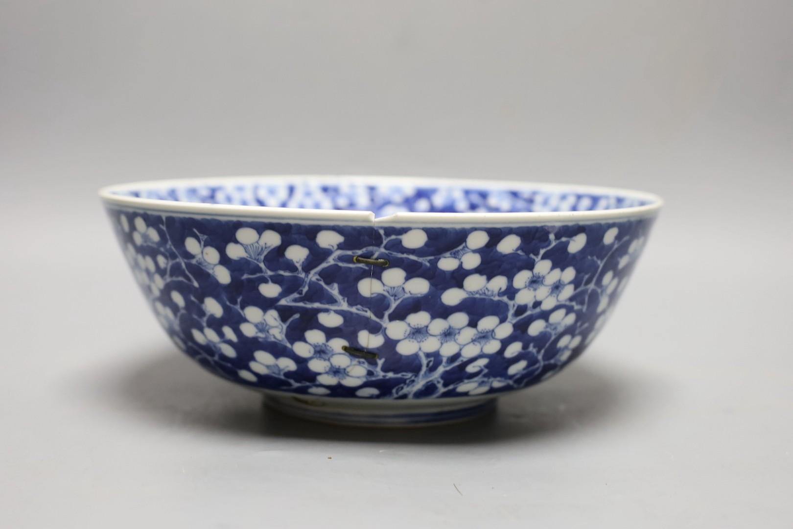 A Chinese blue and white prunus bowl, 19th century. 26.5cm diameter